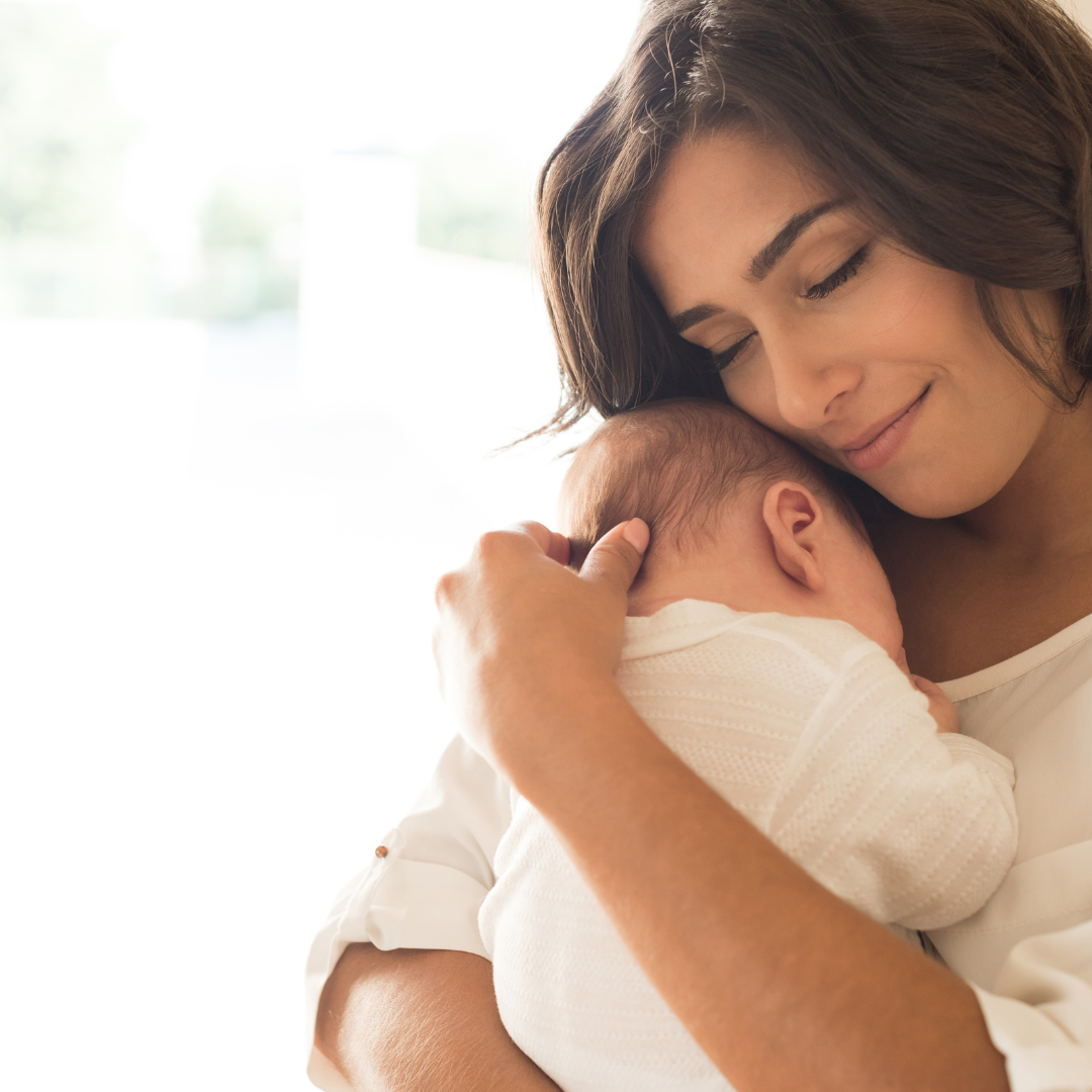 A mother embracing her newborn